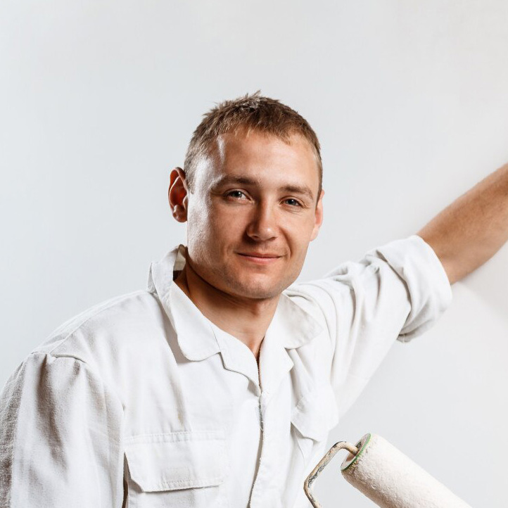 worker-looking-camera-holding-roller_176420-4764
